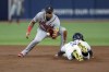 Atlanta Braves' Orlando Arcia waits for the throw before tagging out Tampa Bay Rays' Yandy Diaz on an attempted steal of second base during the third inning of a baseball game Friday, July 7, 2023, in St. Petersburg, Fla. (AP Photo/Mike Carlson)