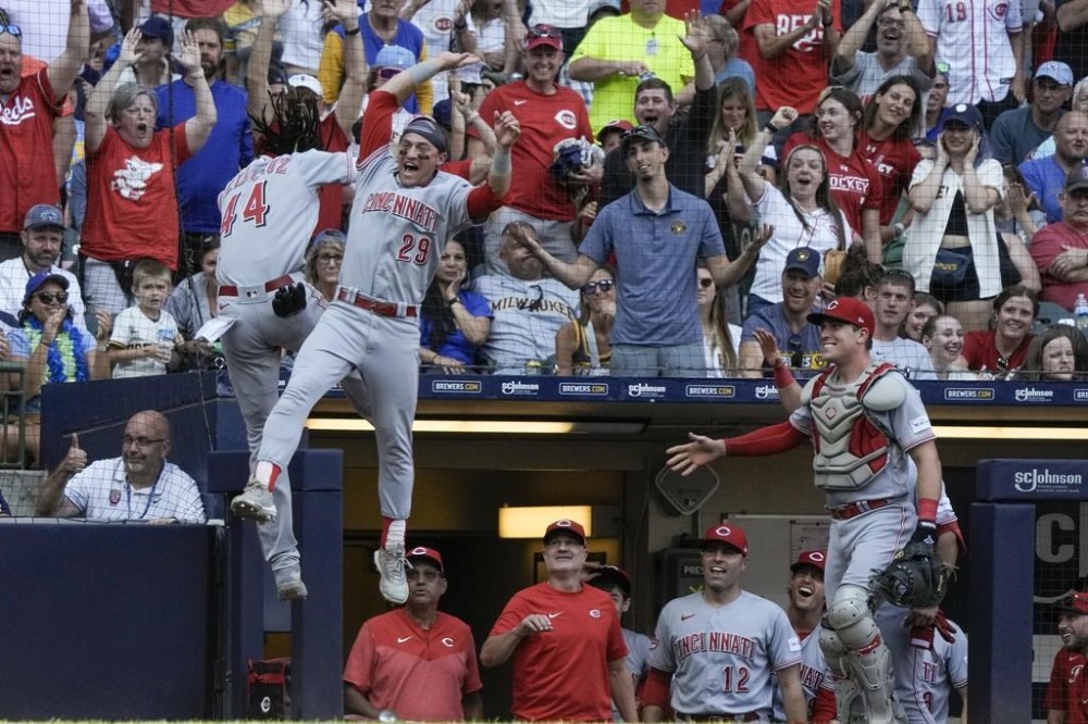 Cincinnati Reds' Elly De La Cruz (44) is congratulated by TJ Friedl after stealing home during the seventh inning of a baseball game against the Milwaukee Brewers Saturday, July 8, 2023, in Milwaukee. (AP Photo/Morry Gash)