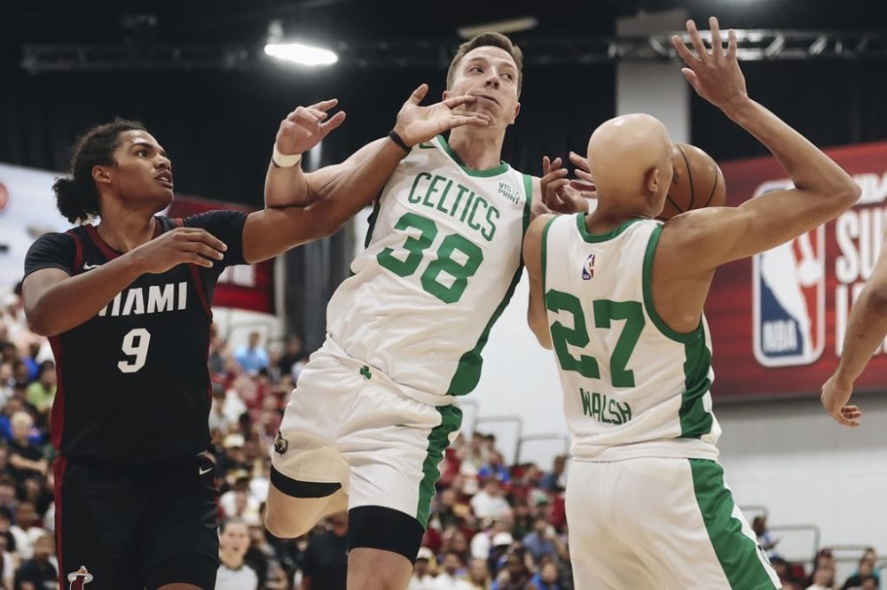 Miami Heat guard Dru Smith (9) swipes the face of Boston Celtics forward Justin Bean (38) during an NBA Summer League basketball game Saturday, July 8, 2023, in Las Vegas. (Madeline Carter/Las Vegas Review-Journal via AP)