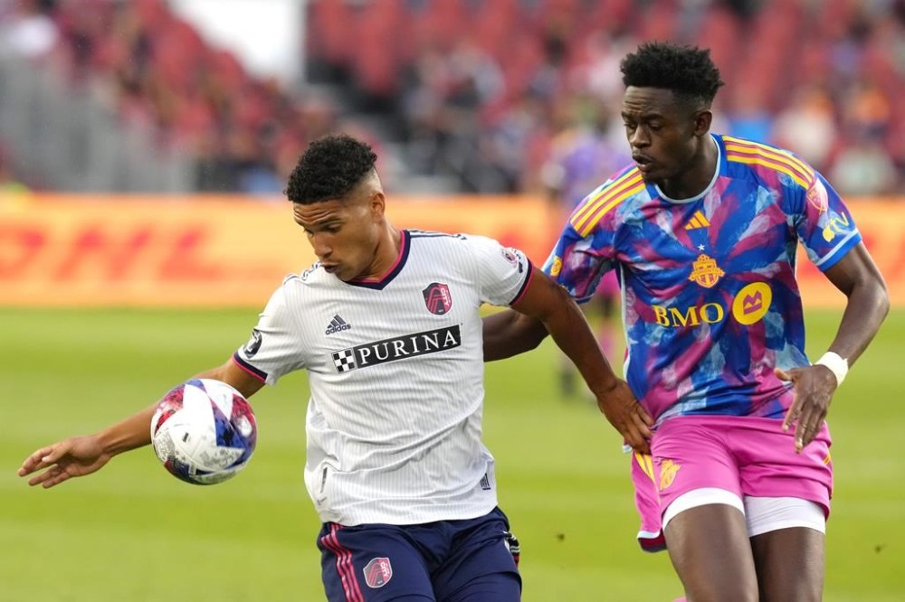 St. Louis City's Nicholas Gioacchini (left) battles for the ball with Toronto FC's Aime Mabika during first half MLS action in Toronto, on Saturday, July 8, 2023.THE CANADIAN PRESS/Chris Young