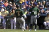 Chicago Cubs' Pete Crow-Armstrong greets Pittsburgh Pirates' Endy Rodriguez, who had scored during the second inning of the All-Star Futures baseball game Saturday, July 8, 2023, in Seattle. (AP Photo/Caean Couto)