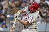 Los Angeles Angels' Mike Moustakas hits an RBI single during the sixth inning of a baseball game against the Los Angeles Dodgers in Los Angeles, Saturday, July 8, 2023. (AP Photo/Kyusung Gong)