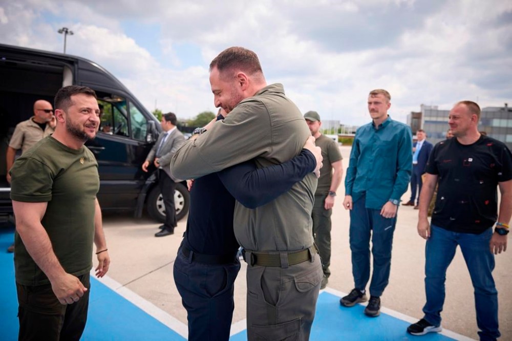 In this photo provided by the Ukrainian Presidential Press Office, Ukrainian President Volodymyr Zelenskyy, left, smiles as Head of the Presidential Office Andriy Yermak, centre, hugs with defender of the Azovstal steel plant Serhii Volynskyi at Istanbul international airport in Istanbul, Turkey, Saturday, July 8, 2023. Five commanders of the defence of the Azovstal steel plant, a gruelling months-long siege early in the war, were returning from Turkey on the plane with Zelenskyy. (Ukrainian Presidential Press Office via AP)