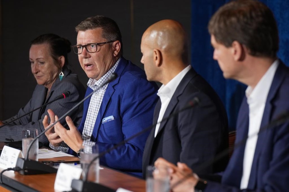 Saskatchewan Premier Scott Moe, second left, speaks as Northwest Territories Premier Caroline Cochrane, back left, Yukon Premier Ranj Pillai, third left, and British Columbia Premier David Eby, right, listen during a news conference following a meeting of western premiers, in Whistler, B.C., on Tuesday, June 27, 2023. THE CANADIAN PRESS/Darryl Dyck