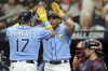 Tampa Bay Rays' Isaac Paredes (17) celebrates his two-run home run with Jonathan Aranda in front of Atlanta Braves catcher Travis d'Arnaud during the first inning of a baseball game, Sunday, July 9, 2023, in St. Petersburg, Fla. (AP Photo/Mike Carlson)