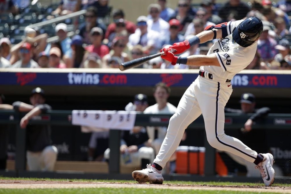 Minnesota Twins' Edouard Julien hits an RBI double against the Baltimore Orioles in the first inning of a baseball game Sunday, July 9, 2023, in Minneapolis. (AP Photo/Andy Clayton-King)
