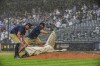 Yankees grounds crew John Salcedo, left, and Carlos Blanco cover the pitchers mount, during a rain delay during a baseball game between the New York Yankees and Chicago Cubs, Sunday, July 9, 2023, in New York. (AP Photo/Bebeto Matthews)