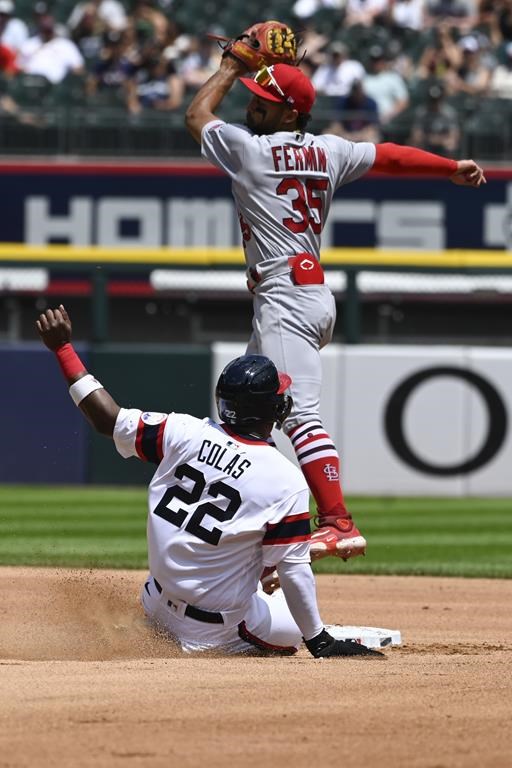 Chicago White Sox's Oscar Colas (22) reaches second base under St. Louis Cardinals shortstop Jose Fermin (35) during the third inning of a baseball game, Sunday, July 9, 2023, in Chicago. (AP Photo/Matt Marton)