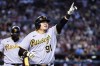 Pittsburgh Pirates' Ji Man Choi (91), of South Korea, celebrates his two-run home run against the Arizona Diamondbacks as Pirates' Carlos Santana, left, walks behind during the second inning of a baseball game, Sunday, July 9, 2023, in Phoenix. (AP Photo/Ross D. Franklin)