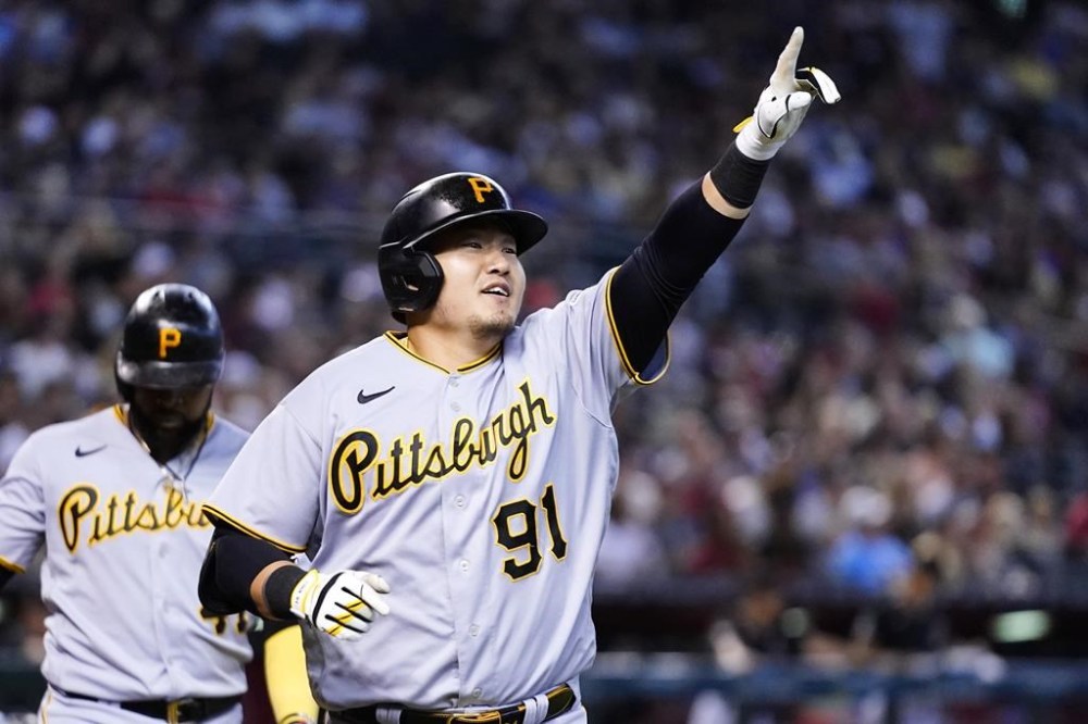 Pittsburgh Pirates' Ji Man Choi (91), of South Korea, celebrates his two-run home run against the Arizona Diamondbacks as Pirates' Carlos Santana, left, walks behind during the second inning of a baseball game, Sunday, July 9, 2023, in Phoenix. (AP Photo/Ross D. Franklin)