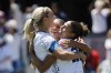 United States midfielder Lindsey Horan, left, and Sophia Smith, center, celebrate with forward Trinity Rodman, right, who scored in the second half of a FIFA Women's World Cup send-off soccer match against Wales in San Jose, Calif., Sunday, July 9, 2023. (AP Photo/Josie Lepe)
