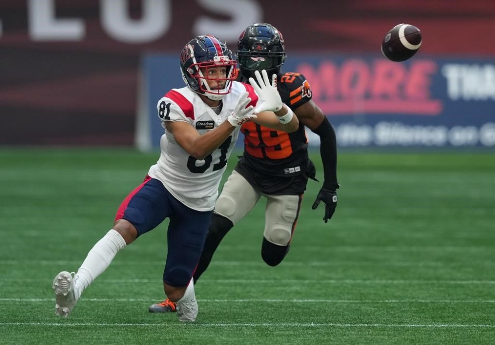 Montreal Alouettes' Austin Mack (81) makes a reception in front of B.C. Lions' Jalon Edwards-Cooper (29) during the first half of a CFL football game, in Vancouver, B.C., Sunday, July 9, 2023. THE CANADIAN PRESS/Darryl Dyck