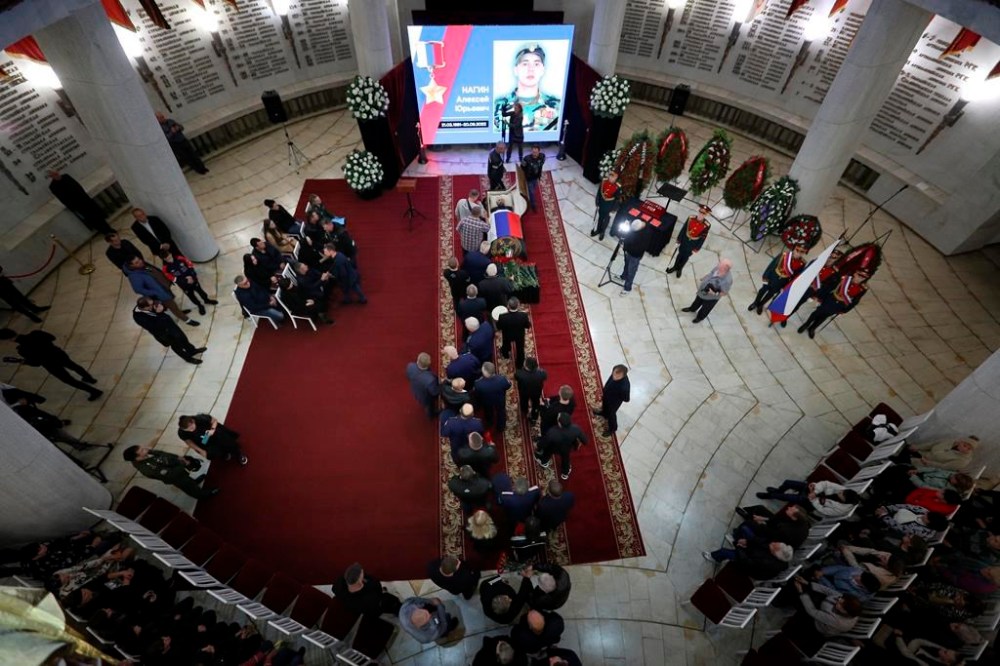 FILE - People attend a mourning ceremony for Alexei Nogin, who was killed in combat in Ukraine, in Volgograd, Russia, on Sept. 24, 2022. Nogin was posthumously awarded with the Hero of Russia medal for fighting in Ukraine. Nearly 50,000 Russian soldiers have died in the war in Ukraine, according to a new statistical analysis. (AP Photo, File)