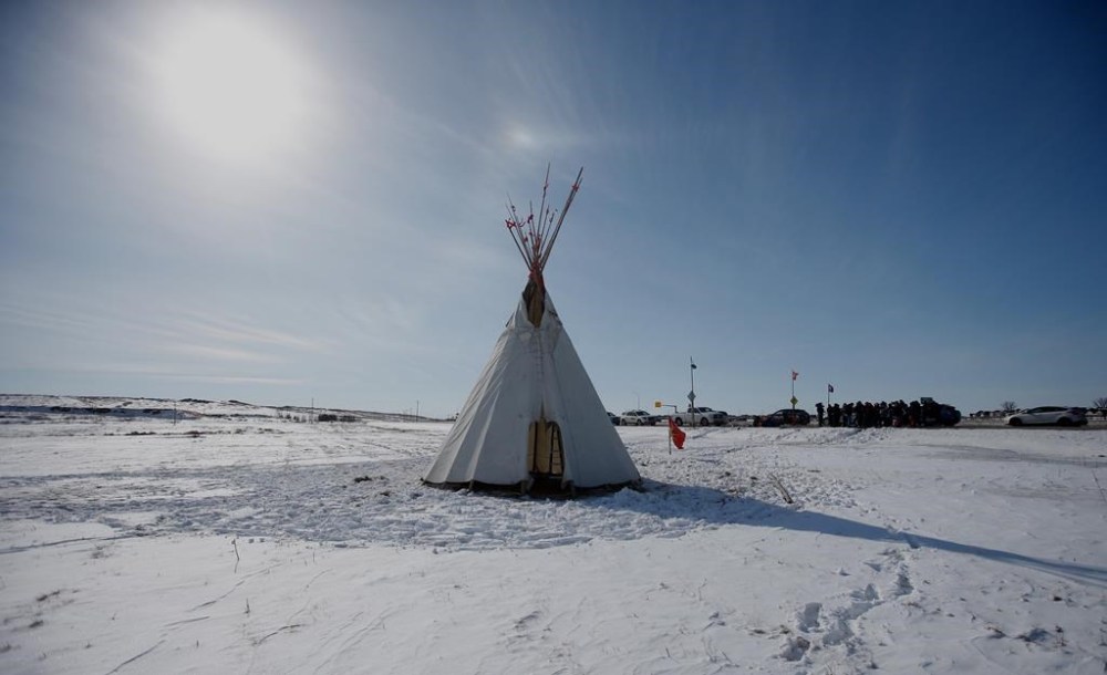 A teepee is shown as Christopher Traverse, Chief of Lake St. Martin First Nation speaks to the media at Winnipeg's Brady Landfill just outside the city, Thursday, April 6, 2023. A protest at a city-owned landfill south of Winnipeg remains in place after they were ordered to leave. THE CANADIAN PRESS/John Woods