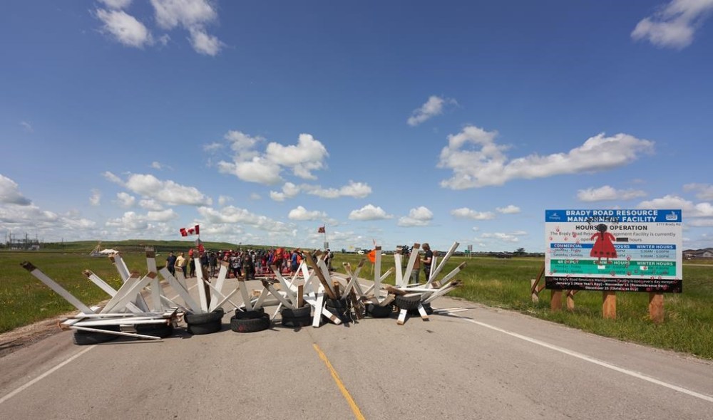 Activists for Indigenous rights blockade the main road into the Brady Road landfill, just outside of Winnipeg, Monday, July 10, 2023, after the city issued an order to vacate the blockade site by Monday at noon. THE CANADIAN PRESS/David Lipnowski