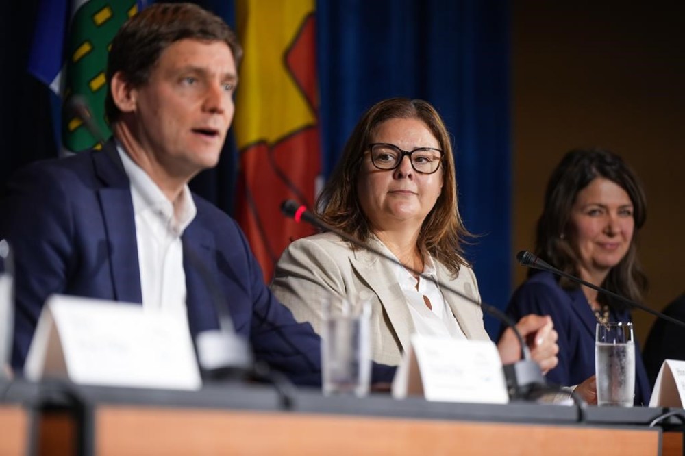 Manitoba Premier Heather Stefanson, centre, and Alberta Premier Danielle Smith, right, listen as British Columbia Premier David Eby speaks during a news conference after a meeting of western premiers, in Whistler, B.C., on Tuesday, June 27, 2023. THE CANADIAN PRESS/Darryl Dyck