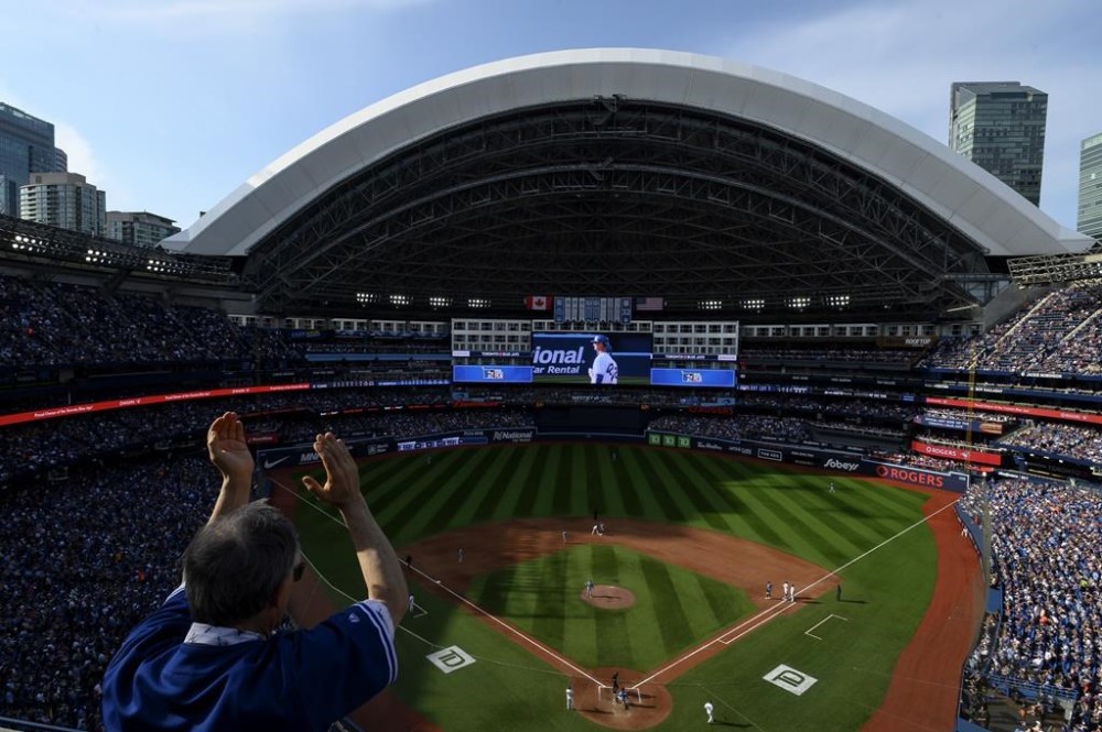 Fans cheer after Toronto Blue Jays' Alejandro Kirk (30) hits an RBI single during seventh inning AL MLB baseball action against the Tampa Bay Rays in Toronto on Saturday, April 15, 2023. THE CANADIAN PRESS/Christopher Katsarov