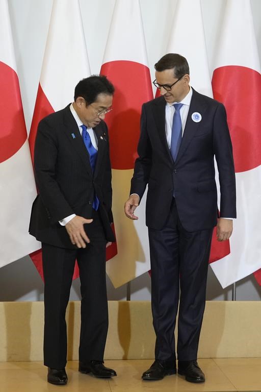 Japan's Prime Minister Fumio Kishida, left, is greeted by his Polish host, Prime Minister Mateusz Morawiecki, right, ahead of their talks on regional security, war in Ukraine and bilateral cooperations in Warsaw, Poland, Tuesday, July 11, 2023. Kishida made a stop in Warsaw on his way to NATO summit in Vilnius, Lithuania. (AP Photo/Czarek Sokolowski)