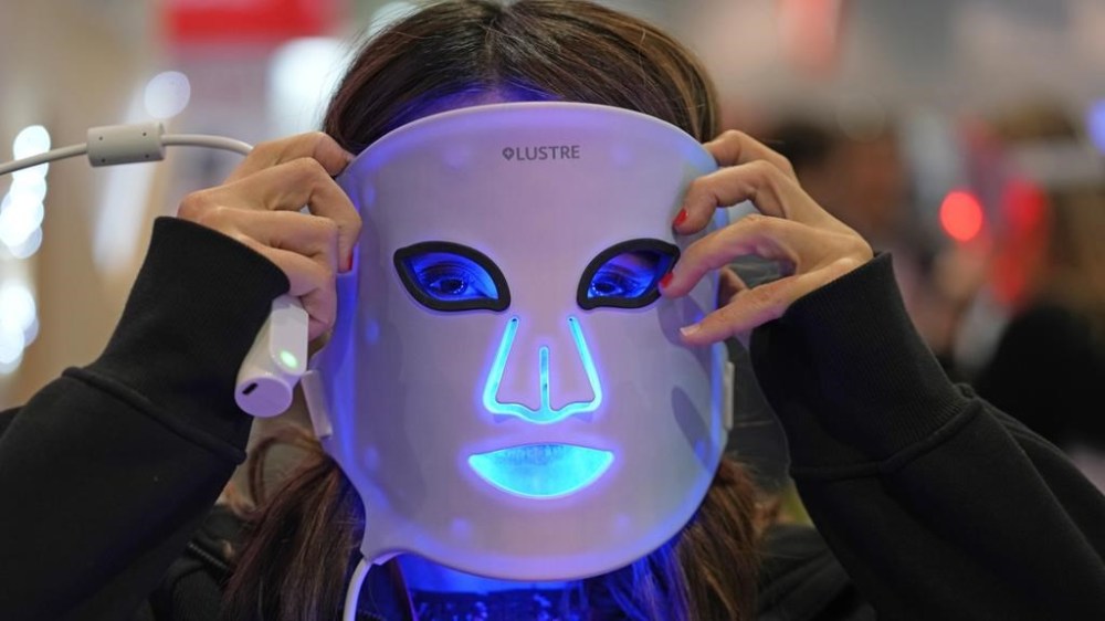 Kimberly Lafleur from LUSTRE ClearSkin wears the revive mask at the company booth during the CES tech show in Las Vegas, Friday, Jan. 6, 2023. One in 10 Canadians spend more than $500 on skin care every year, but it isn't as simple as opting out, especially for women. THE CANADIAN PRESS/AP-Rick Bowmer