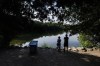 People look out on the water from the shore of Crawford Lake in Milton, Ont., on Friday, July 7, 2023. THE CANADIAN PRESS/Cole Burston