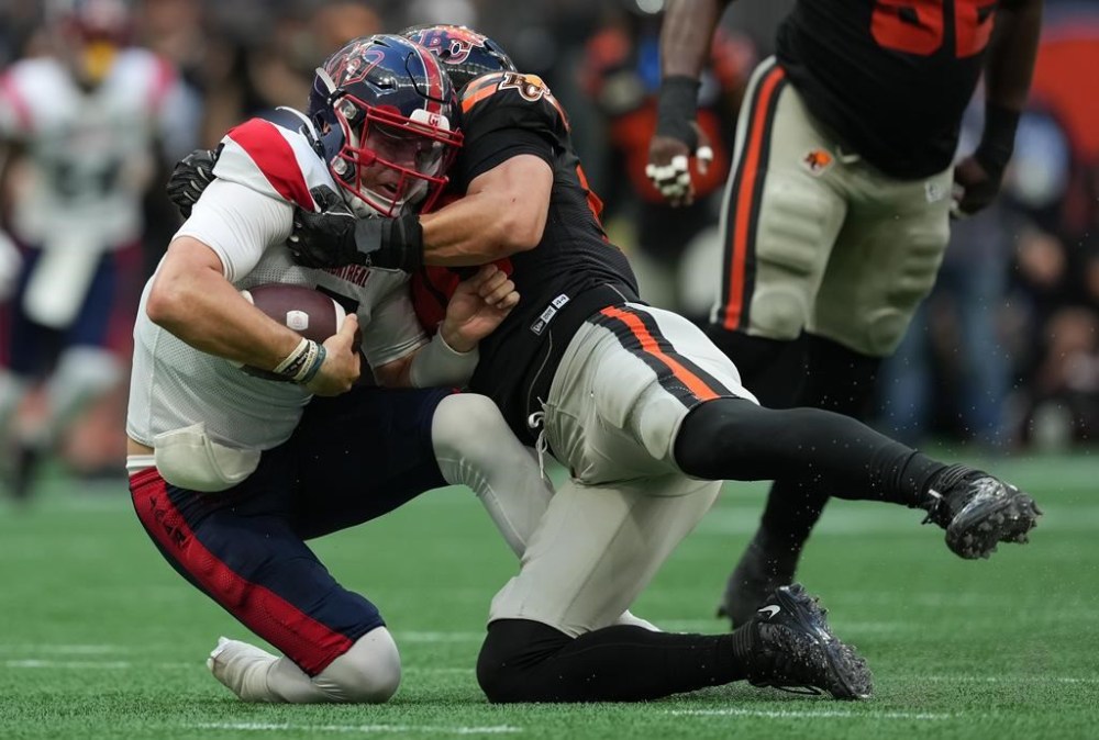 Montreal Alouettes quarterback Cody Fajardo, left, is sacked by B.C. Lions' Mathieu Betts during the first half of a CFL football game, in Vancouver, B.C., Sunday, July 9, 2023. CFL offences are getting a break from Betts and the Lions defence. B.C. (4-1) has a league-high 21 sacks this season. The six-foot-three, 250-pound Betts has a CFL-best nine sacks, a career high that matches his combined total over the previous three seasons. THE CANADIAN PRESS/Darryl Dyck