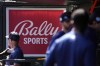 FILE -A Bally Sports sign hangs in a dugout before the start of a spring training baseball game between the St. Louis Cardinals and Houston Astros Thursday, March 2, 2023, in Jupiter, Fla. Major League Baseball says teams have collected 94% of the money they have been owed by Diamond Sports. The company owns 19 networks under the Bally Sports banner and has been in Chapter 11 bankruptcy proceedings in Texas since March. MLB took over rights to San Diego Padres telecasts on May 31 after a rights payment was missed.(AP Photo/Jeff Roberson, File)