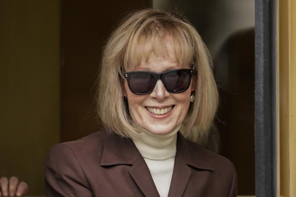 FILE - E. Jean Carroll walks out of federal court in Manhattan, May 9, 2023, in New York. The Justice Department on Tuesday, July 11, 2023, said that former President Donald Trump can be held personally liable for remarks he made about a Carroll, who accused him of rape, a reversal of its position that Trump was protected because he was president when he made the remarks. (AP Photo/John Minchillo, File)
