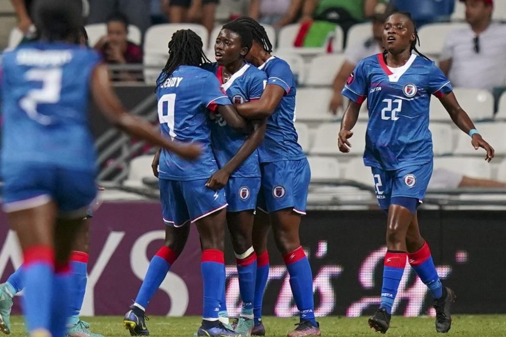 FILE - Haiti's Nerilia Mondesir , center, is congratulated by teammates after scoring her side's second goal against Mexico during a CONCACAF Women's Championship soccer match in Monterrey, Mexico, Thursday, July 7, 2022. (AP Photo/Fernando Llano, File)