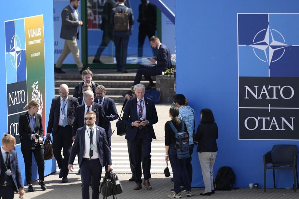 Finland's President Sauli Niinisto, center, walks with his delegation at the venue of a NATO summit in Vilnius, Lithuania, Wednesday, July 12, 2023. NATO leaders prepared to provide Ukraine with more military assistance for fighting Russia but only vague assurances of future membership as the alliance's summit draws to a close on Wednesday. (AP Photo/Pavel Golovkin)