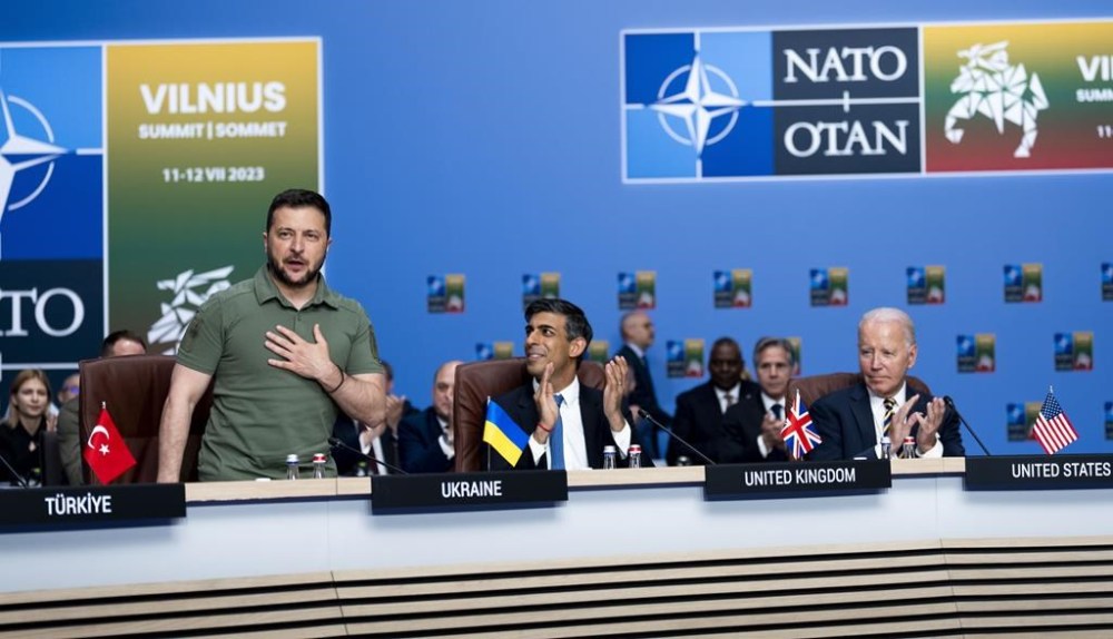 President Volodymyr Zelensky of Ukraine, left, receives applause from NATO members including British Prime Minister Rishi Sunak, center, and U.S. President Joe Biden during a meeting of the NATO-Ukraine Council at the level of Heads of State and Government, with Sweden, at the NATO Summit in Vilnius, Lithuania, Wednesday, July, 12, 2023. (Doug Mills/Pool via AP)