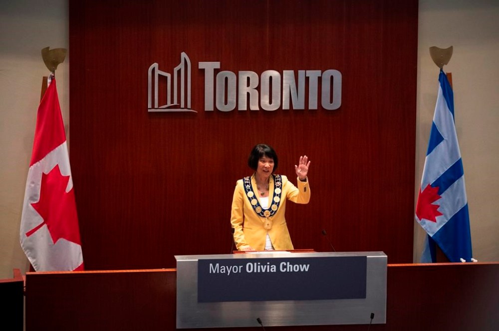 Newly elected Mayor Olivia Chow waves to the crowd at council chambers during her declaration of office ceremony, at Toronto City Hall on Wednesday, July 12, 2023. THE CANADIAN PRESS/Tijana Martin