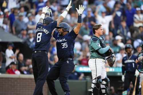 National League's Elias Díaz, of the Colorado Rockies (35), celebrates his two run home run with Nick Castellanos (8), of the Philadelphia Phillies, in the eighth inning during the MLB All-Star baseball game in Seattle, Tuesday, July 11, 2023. (AP Photo/Lindsey Wasson)