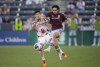 Colorado Rapids midfielder Braian Galvan, right, kicks the ball as Portland Timbers defender Claudio Bravo defends in the second half of an MLS soccer match Wednesday, July 12, 2023, in Commerce City, Colo. The first half of the match was played Tuesday, July 4, before it was delayed by a rainstorm and rescheduled for Wednesday, July 12. (AP Photo/David Zalubowski)