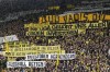 FILE - Fans hold up banners protesting against investors in German soccer during the German Bundesliga soccer match between Borussia Dortmund and Union Berlin in Dortmund, Germany, Saturday, April 8, 2023. German soccer’s 50-plus-1 rule designed to prevent the outside takeover of clubs has been given the all-clear and strengthened by the country’s federal competition authority. (AP Photo/Martin Meissner, File)