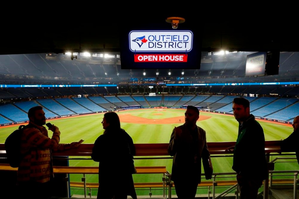 People hang out at the Corona Rooftop Patio during a tour of the Snew renovations completed to the Rogers Centre stadium, home of the Toronto Blue Jays, in Toronto, Thursday, April 6, 2023. The Toronto Blue Jays will embark on a second consecutive 10-game season-opening road trip to start the next Major League Baseball campaign as renovations are set to continue at Rogers Centre.THE CANADIAN PRESS/Cole Burston