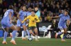 Australia's Katrina Gorry, center, Carris the ball up through France's defense during their friendly soccer match in Melbourne, Friday, July 14, 2023, ahead of the Women's World Cup. (AP Photo/Hamish Blair)