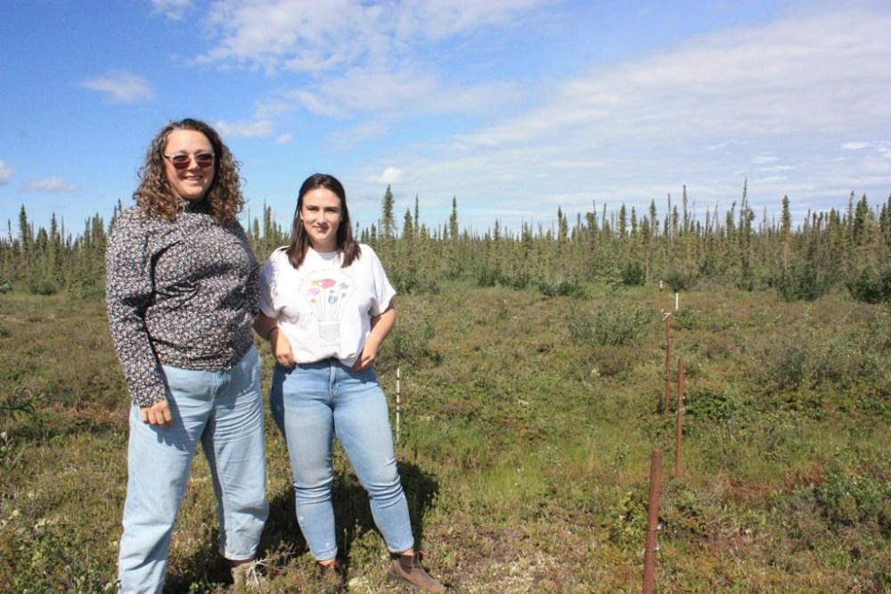 Erica Hille, acting director at the Western Arctic Research Centre, left, and Jennifer Humphries, permafrost specialist at the Aurora Research Institute, at a monitoring site in Inuvik, N.W.T., July 5, 2023. THE CANADIAN PRESS/Emily Blake