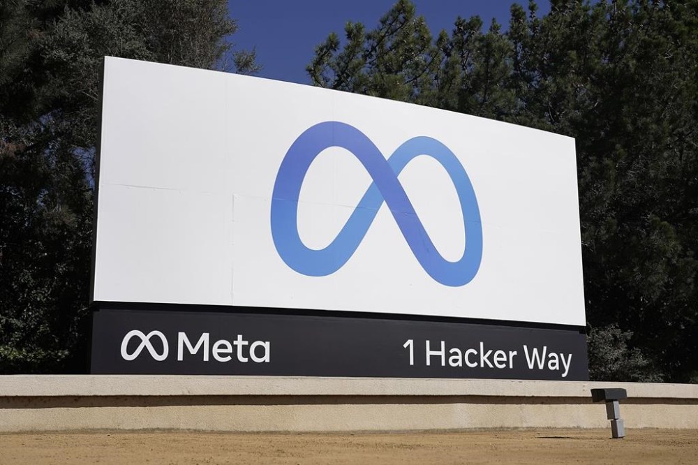 FILE - Facebook's Meta logo sign is seen at the company headquarters in Menlo Park, Calif. on Oct. 28, 2021. Thirteen state attorneys general – all Republicans – sent a letter Thursday, July 13, 2023, to the CEOs of the U.S.'s 100 biggest companies, warning of legal consequences for using race as a factor in hiring and employment practices. (AP Photo/Tony Avelar, File)