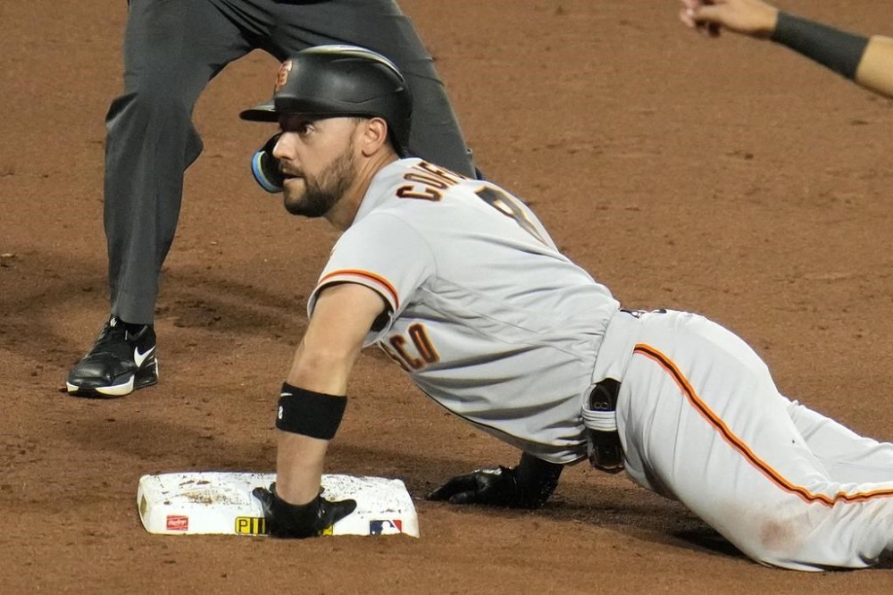 San Francisco Giants' Michael Conforto, slides safely into second base after driving in two runs with a single off Pittsburgh Pirates relief pitcher David Bednar in the eighth inning of a baseball game in Pittsburgh, Saturday, July 15, 2023. (AP Photo/Gene J. Puskar)