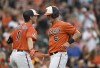 Baltimore Orioles' Ryan Moutcastle, right, is congratulated by Jordan Westburg after scoring on a single by Cedric Mullins against the Miami Marlins in the second inning of a baseball game Saturday, July 15, 2023, in Baltimore. (AP Photo/Gail Burton)