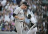 New York Yankees pitcher Clarke Schmidt, front, reacts after giving up a solo home run to Colorado Rockies' C.J. Cron during the seventh inning of a baseball game Saturday, July 15, 2023, in Denver.(AP Photo/David Zalubowski)