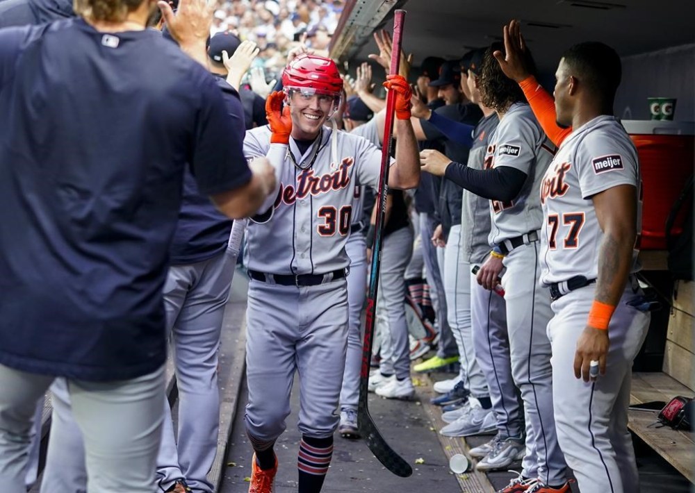 Detroit Tigers' Kerry Carpenter holds a hockey stick and wears a helmet in the dugout during the fifth inning as he celebrates hitting his second home run of the team's baseball game against the Seattle Mariners, Saturday, July 15, 2023, in Seattle. (AP Photo/Lindsey Wasson)