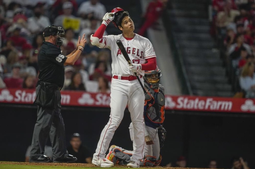 Los Angeles Angels designated hitter Shohei Ohtani takes off his helmet after swinging for a strike during the seventh inning of a baseball game against the Houston Astros, Saturday, July 15, 2023, in Anaheim, Calif. (AP Photo/Ryan Sun)