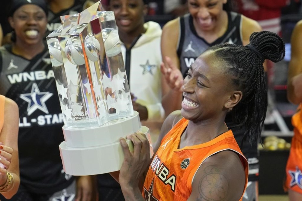 Seattle Storm's Jewell Loyd, of Team Stewart, holds up the MVP trophy after winning the award after a WNBA All-Star basketball game Saturday, July 15, 2023, in Las Vegas. (AP Photo/John Locher)