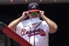 Atlanta Braves manager Brian Snitker (43) adjusts his sunglasses as he waits for a baseball game against the Chicago White Sox, Sunday, July 16, 2023, in Atlanta. (AP Photo/John Bazemore)