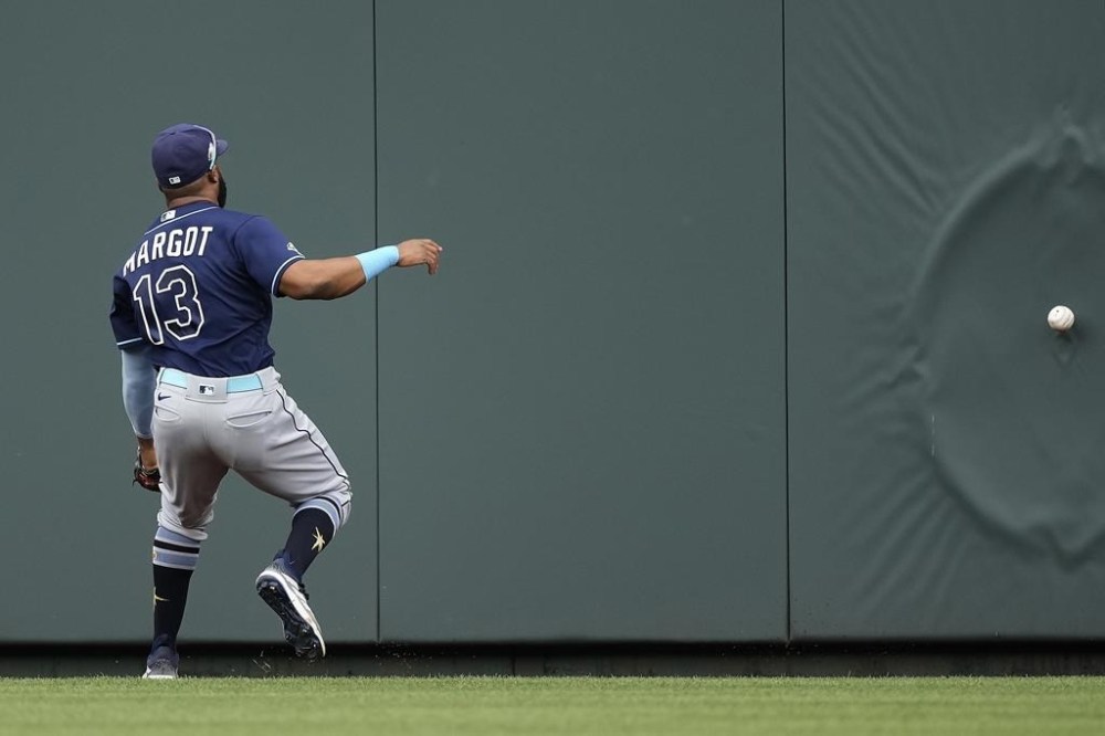 Tampa Bay Rays center fielder Manuel Margot chases after a two-run triple hit by Kansas City Royals' Bobby Witt Jr. during the second inning of a baseball game Sunday, July 16, 2023, in Kansas City, Mo. (AP Photo/Charlie Riedel)