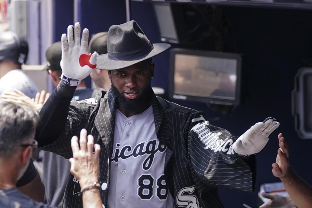 Chicago White Sox's Luis Robert Jr. (88) celebrates in the dugout after hitting a two-run home run in the sixth inning of a baseball game against the Atlanta Braves, Sunday, July 16, 2023, in Atlanta. (AP Photo/John Bazemore)