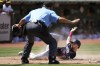 Home plate umpire Chad Fairchild, top, signals safe as Minnesota Twins' Edouard Julien, bottom, scores during the seventh inning of a baseball game against the Oakland Athletics in Oakland, Calif., Sunday, July 16, 2023. (AP Photo/Jeff Chiu)