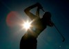 FILE - A golfer is silhouetted against the sun while teeing off on the third hole during the first round of the Women's British Open golf tournament at Royal Lytham and St Annes golf course in Lytham, north west England Thursday, Aug. 3, 2006. Kerry Bowie's daughters have dreams. Big ones. “There are some things people miss out on by not doing it,” Bowie says. “To be that young lady who plays golf, it changes things.” (AP Photo/Matt Dunham, File)