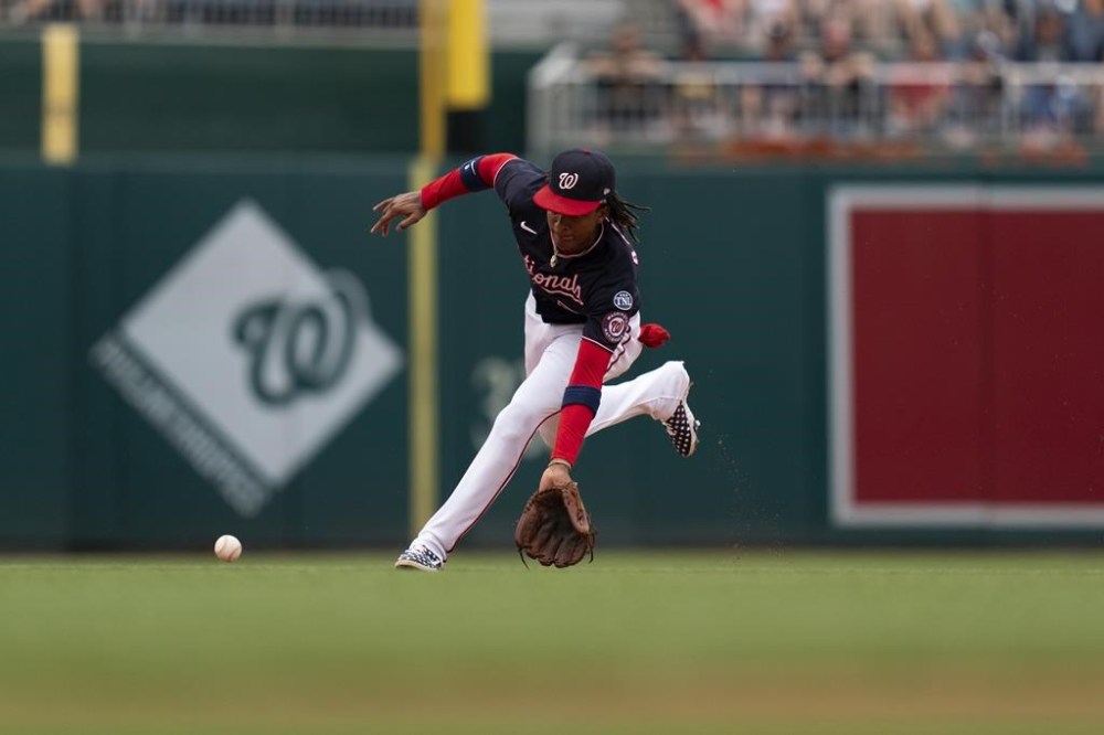 Washington Nationals shortstop CJ Abrams catches a ground ball during the fourth inning of a baseball game against the Texas Rangers, Sunday, July 9, 2023, in Washington. (AP Photo/Stephanie Scarbrough)